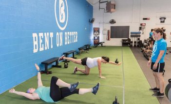 two women in a pre/postnatal fitness class doing core work