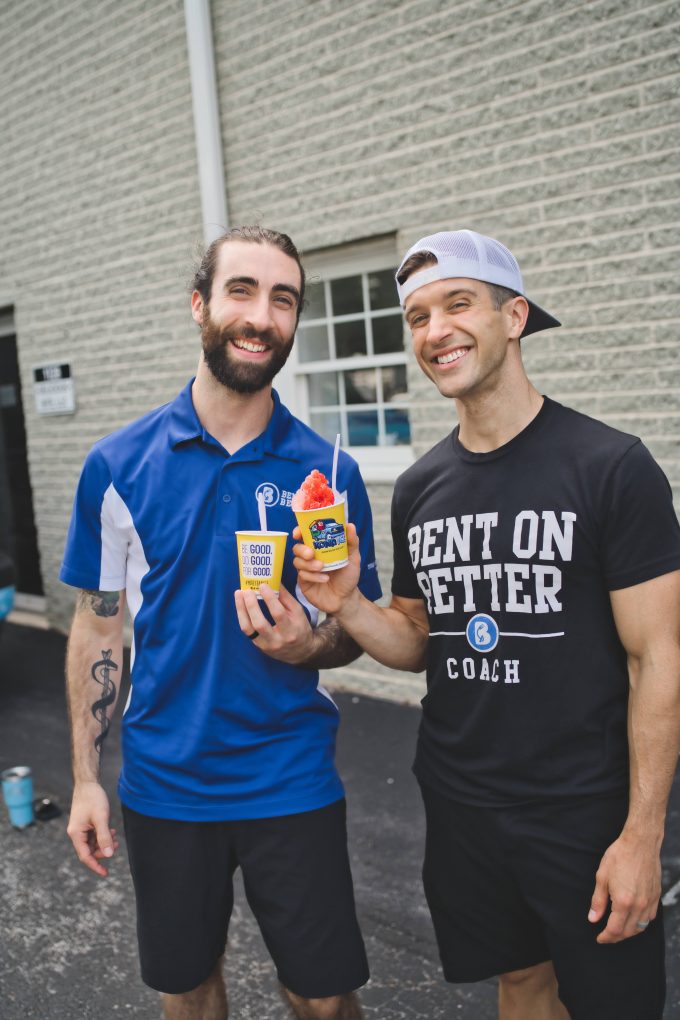 2 men holding a cup of ice cream