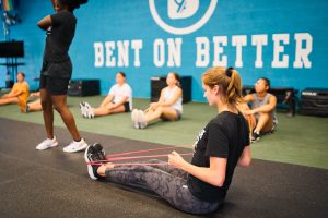 Young women working out using resistance bands in a gym