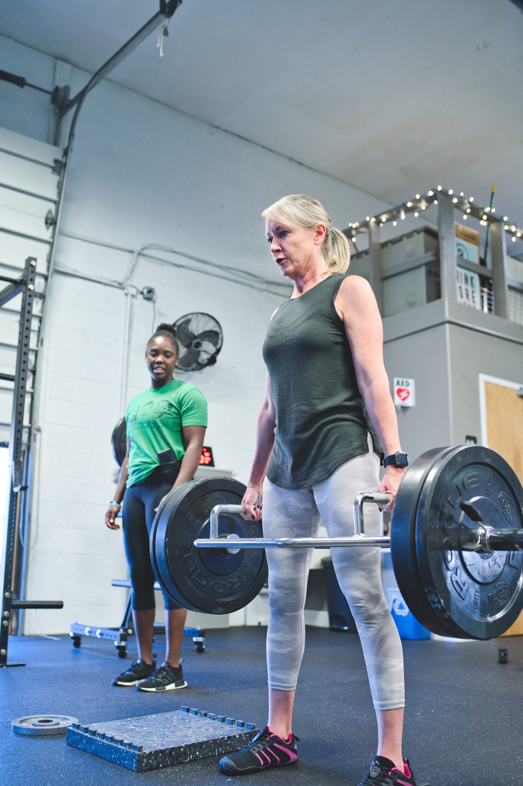 A woman deadlifting in a gym