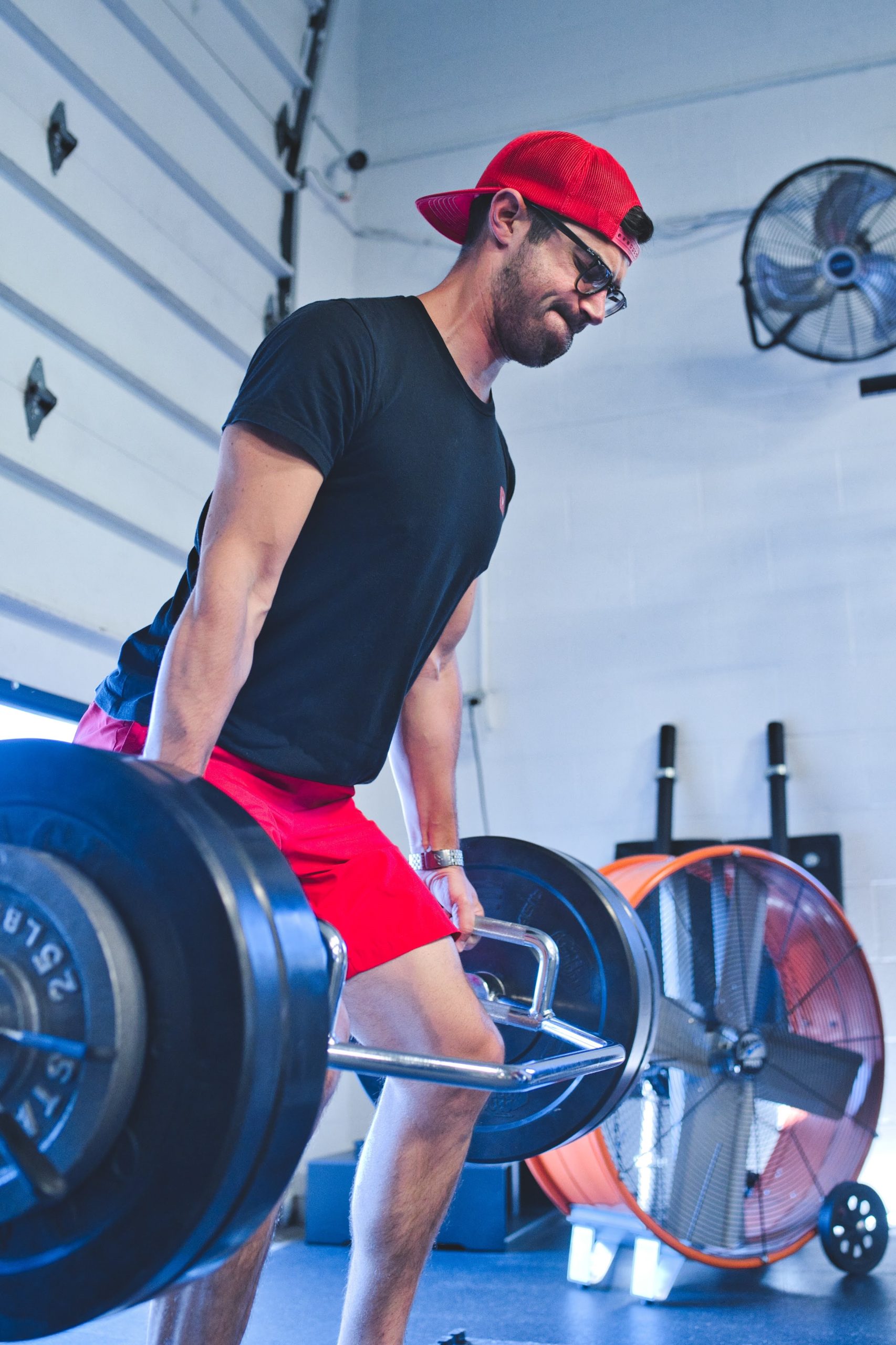 a man doing a trap bar deadlift in a gym